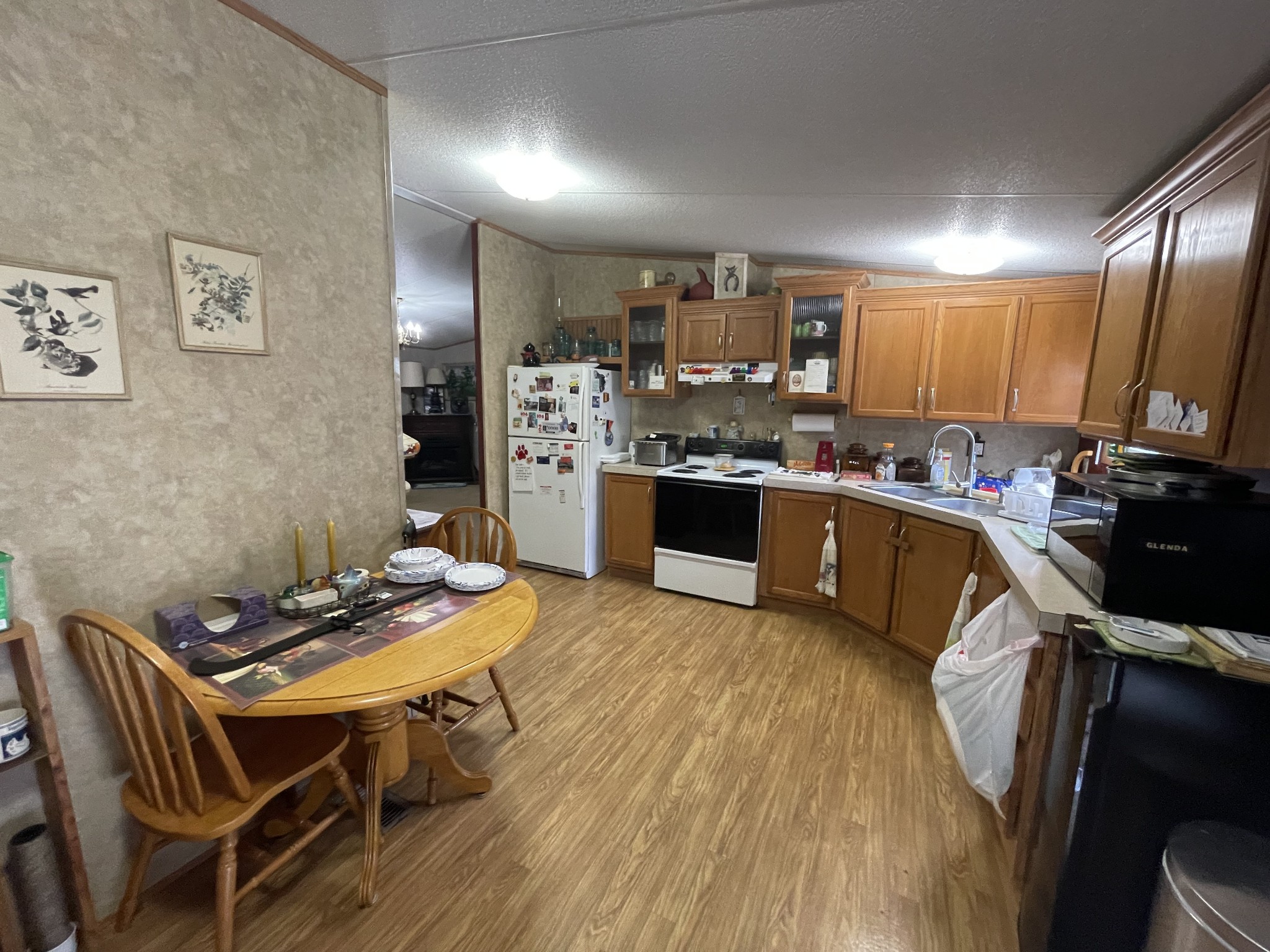 3556 Goshen Road Santa Fe, TN 38482 - Photo 9 of 22 a kitchen with stainless steel appliances kitchen island granite countertop a sink dishwasher stove refrigerator and couches with wooden floor