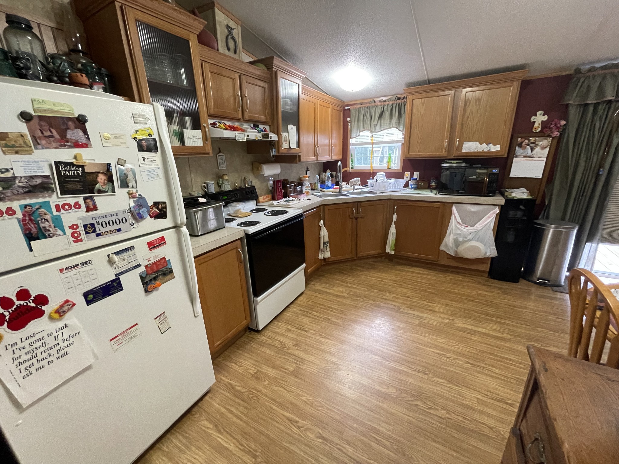 3556 Goshen Road Santa Fe, TN 38482 - Photo 10 of 22 a kitchen with stainless steel appliances granite countertop a sink a stove a refrigerator wooden floor and cabinets