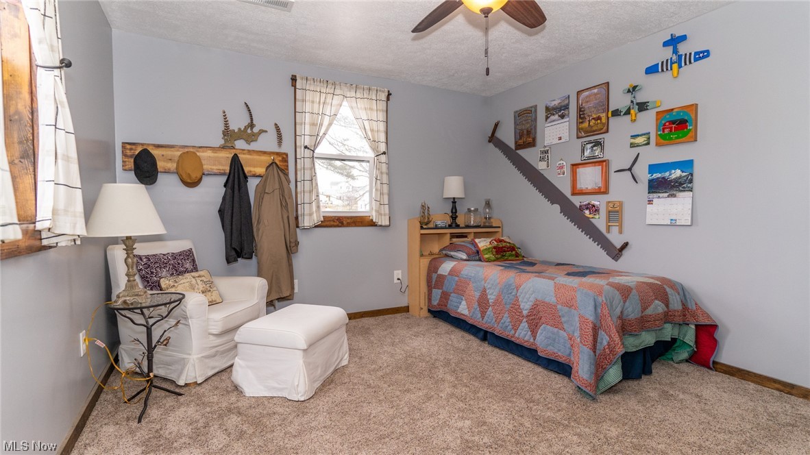 13962 Nickel Plate Road Logan, OH 43138 - Photo 29 of 46 Bedroom featuring light colored carpet, a textured ceiling, and ceiling fan