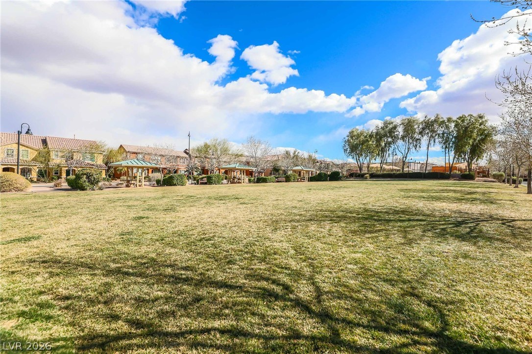 3175 Via Seranova Henderson, NV 89044 - Photo 41 of 45 Expansive green space bordered by residential buildings, perfect for community gatherings.