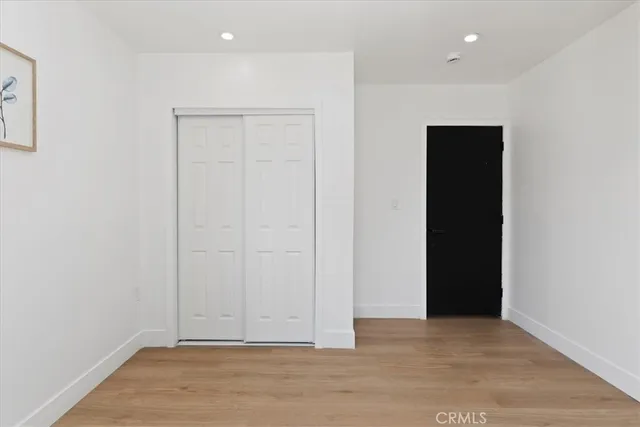 an empty room with wooden floor