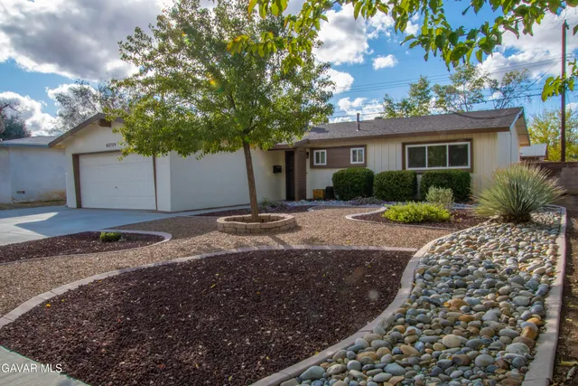 a front view of a house with a yard and a garage