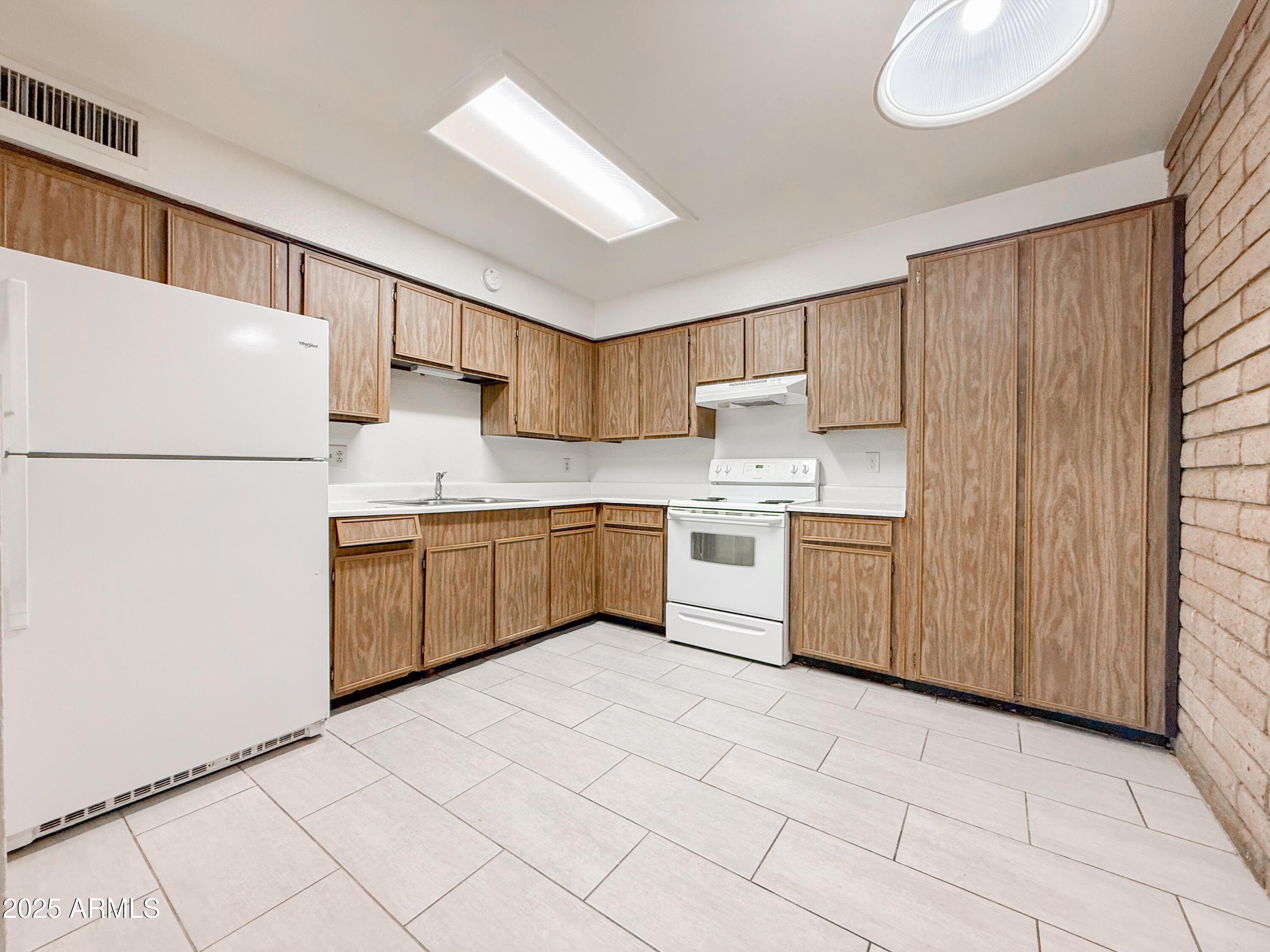 2219 West Morten Avenue, Unit 5 Phoenix, AZ 85021 - Photo 7 of 13 a kitchen with a white refrigerator stove a sink dishwasher and a refrigerator with wooden floor