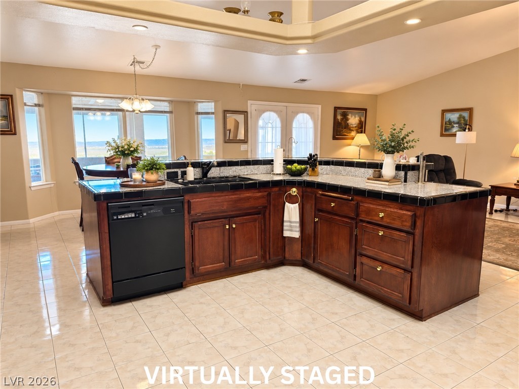 5470 Grain Mill Road Pahrump, NV 89061 - Photo 10 of 80 VIRTUALLY STAGED Rich wood cabinetry anchors the central island under recessed lighting and tray ceiling details.