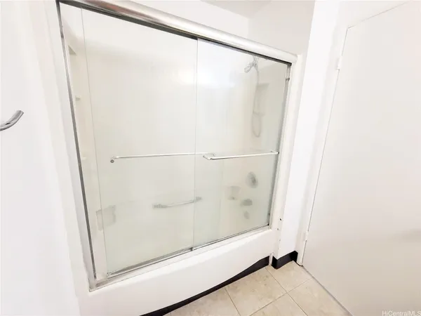 a bathroom with a glass shower door