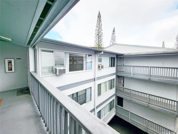 a view of a house with a deck and wooden fence
