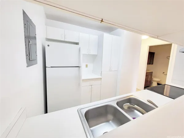 a kitchen with a refrigerator and a sink