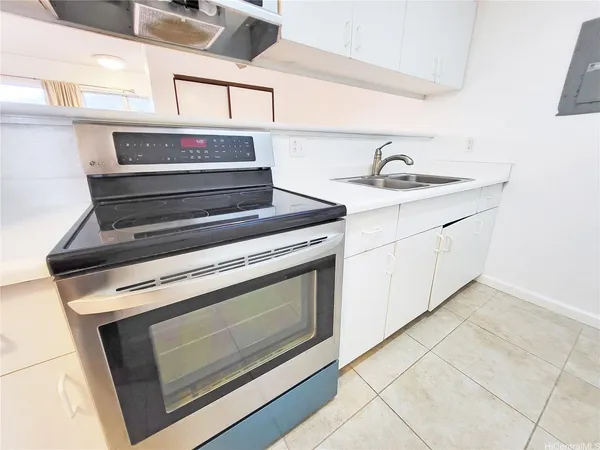 a stove top oven sitting inside of a kitchen