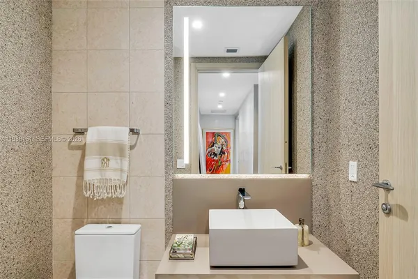 a bathroom with a sink a mirror and a toilet