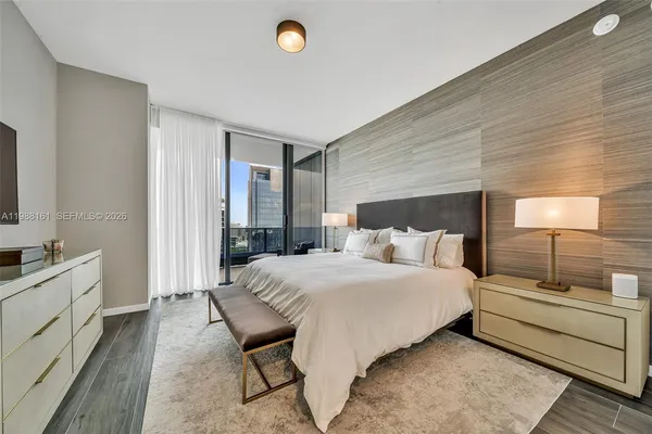 a bedroom with a bed and a night stand
