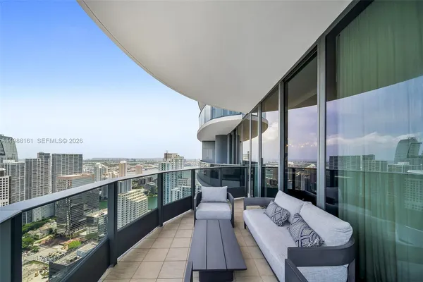 a balcony with furniture and city view