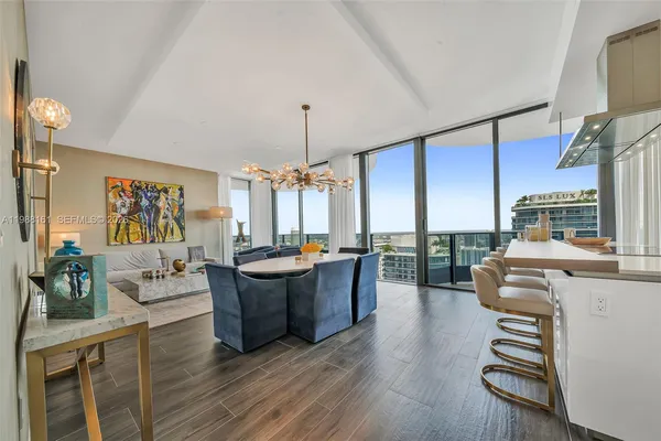 a living room with furniture fireplace and potted plants