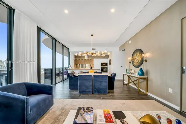 a living room with furniture and a chandelier