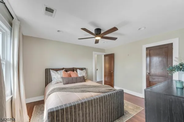 a bedroom with a bed and a ceiling fan