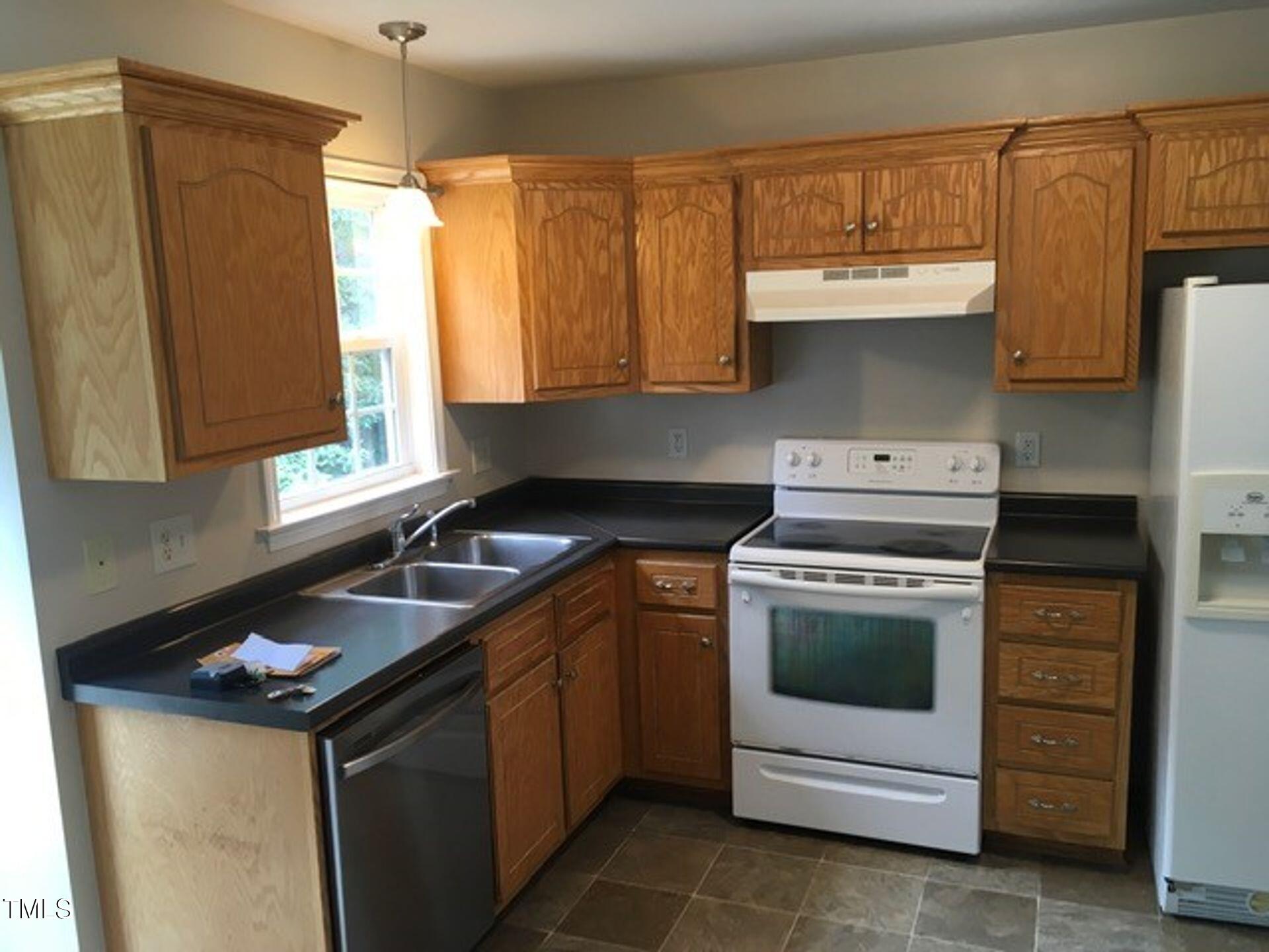 482 Sunray Drive Clayton, NC 27520 - Photo 4 of 12 a kitchen with a stove sink and cabinets