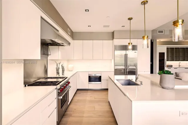 a kitchen with counter top space and stainless steel appliances