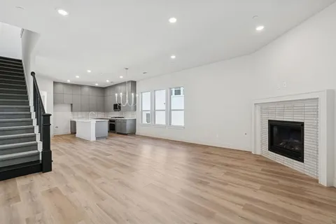 a view of a kitchen with a sink and a fireplace