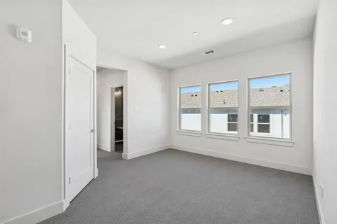 an empty room with a empty space and windows