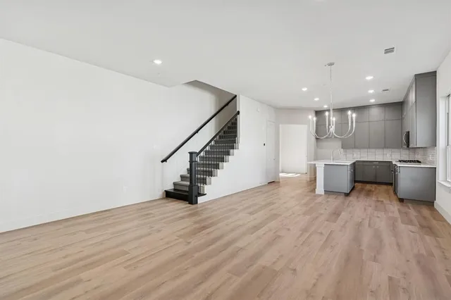 a view of a kitchen with a sink and wooden floor
