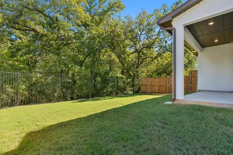 a view of a yard with large trees