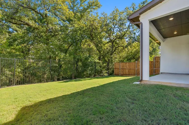 a view of a yard with large trees