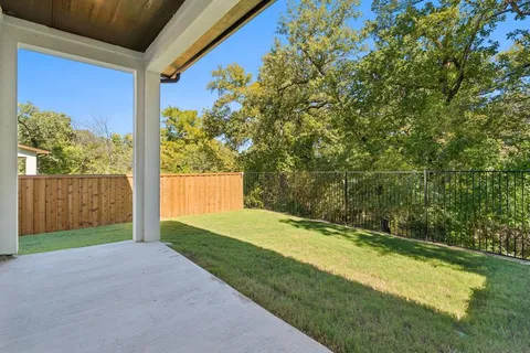 a view of a backyard with a large tree