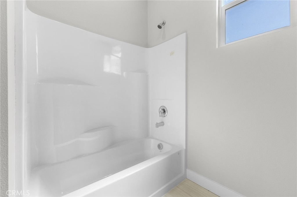 1341 East 8th Street Beaumont, CA 92223 - Photo 12 of 38 a bathroom with a bathtub and shower