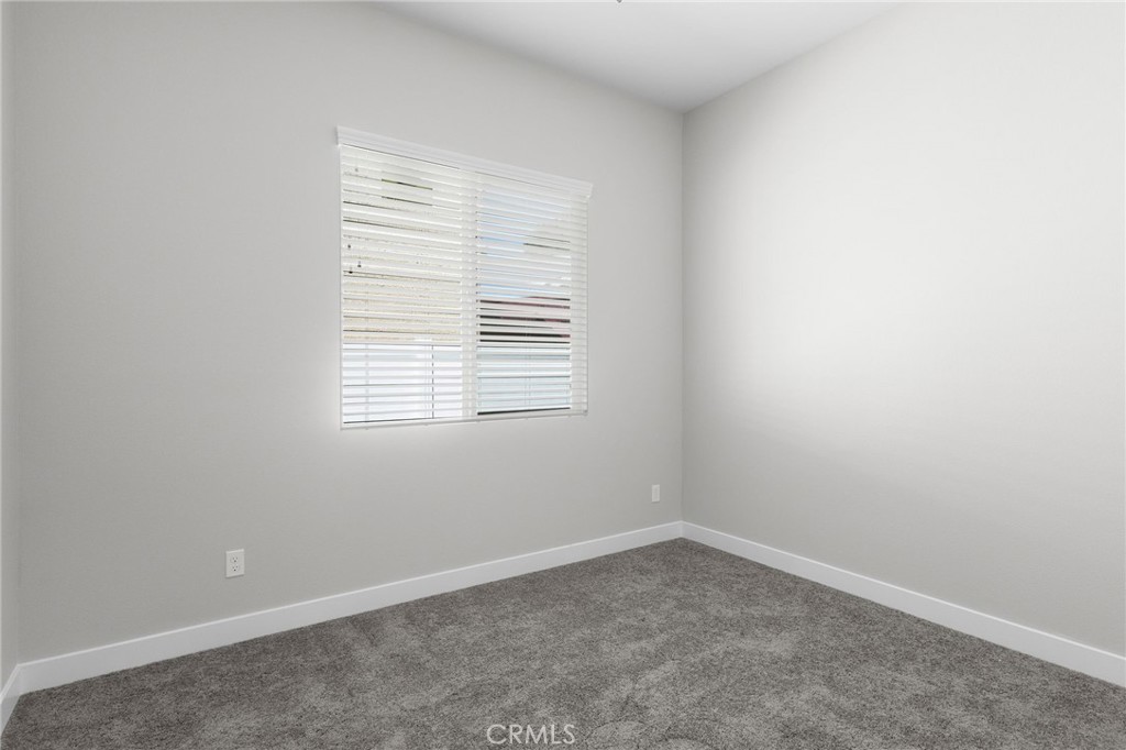 1341 East 8th Street Beaumont, CA 92223 - Photo 24 of 38 an empty room with a window