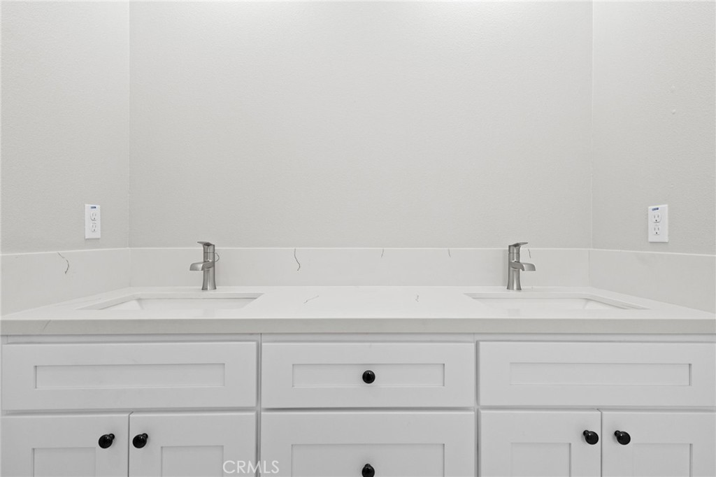 1341 East 8th Street Beaumont, CA 92223 - Photo 28 of 38 a bathroom with a sink and cabinets