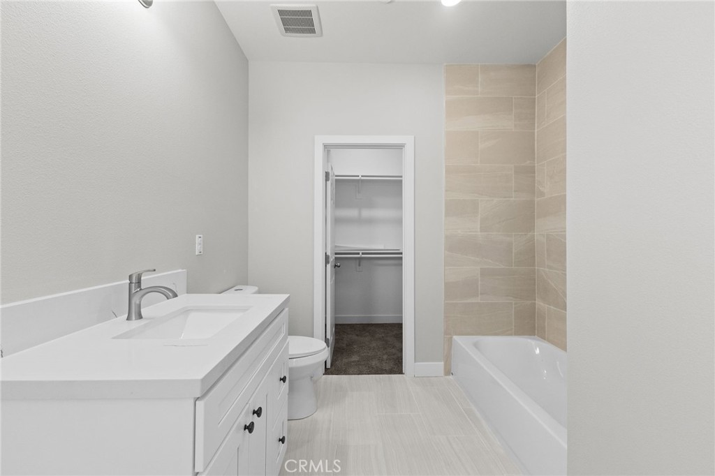 1341 East 8th Street Beaumont, CA 92223 - Photo 29 of 38 a bathroom with a sink a toilet and shower