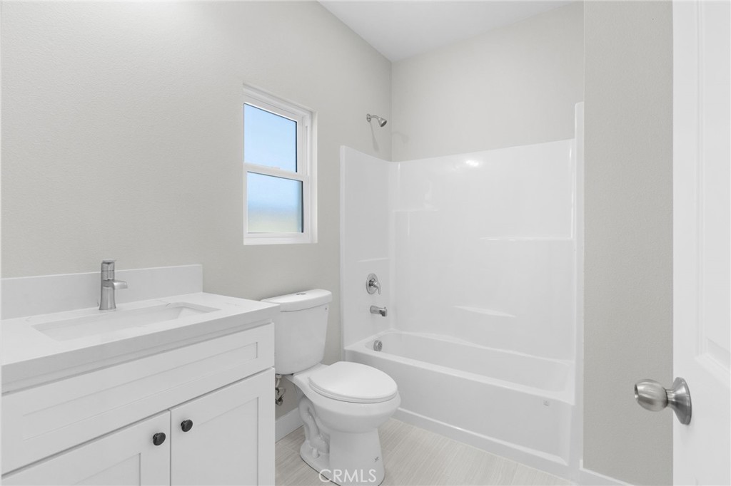 1341 East 8th Street Beaumont, CA 92223 - Photo 31 of 38 a bathroom with a sink a toilet and shower