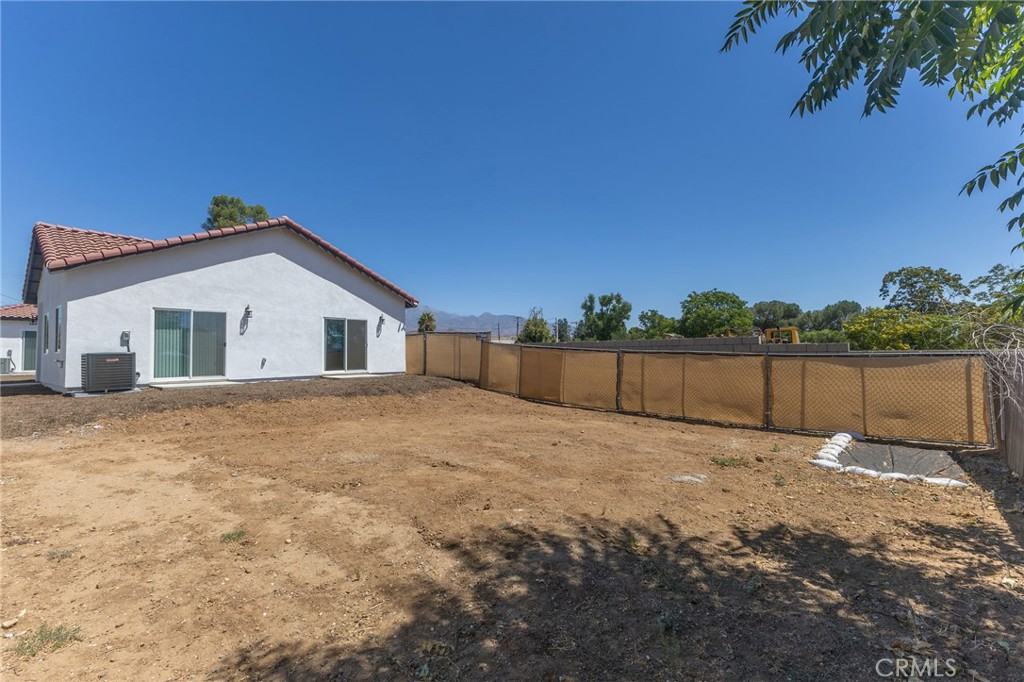 1341 East 8th Street Beaumont, CA 92223 - Photo 33 of 38 a backyard of a house with a yard