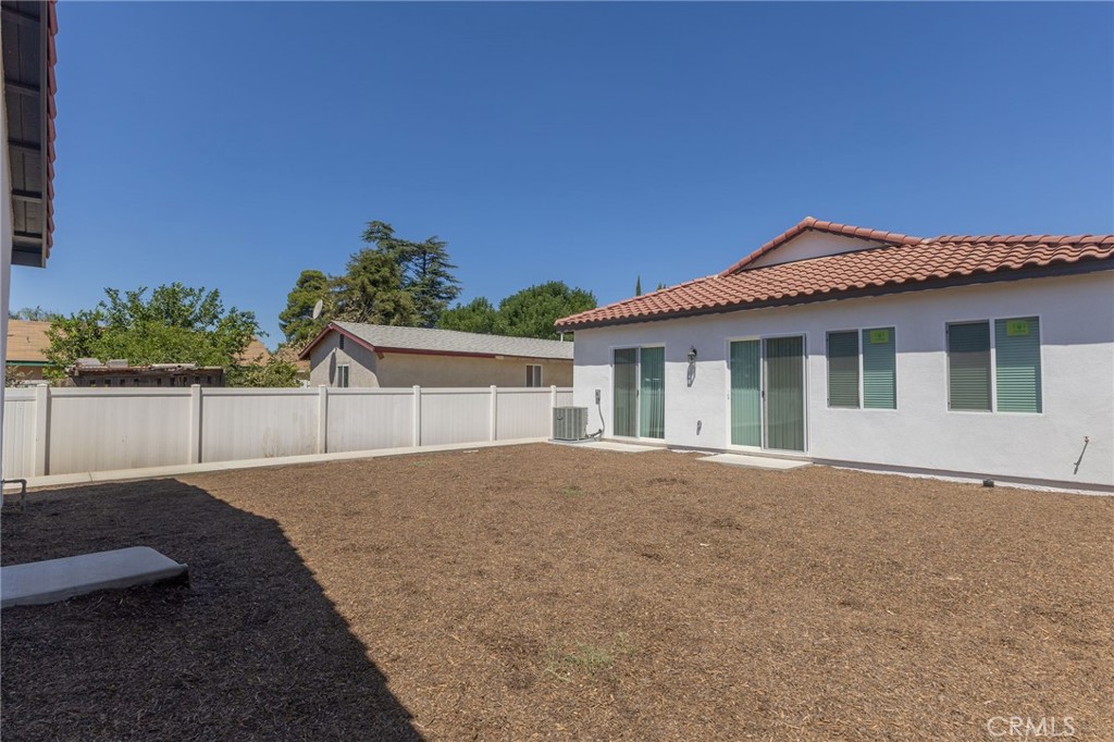 1341 East 8th Street Beaumont, CA 92223 - Photo 36 of 38 a front view of a house with a garden and yard