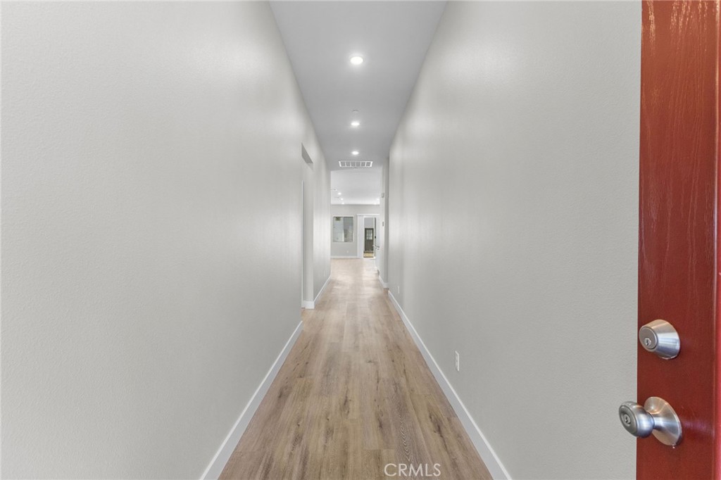1341 East 8th Street Beaumont, CA 92223 - Photo 7 of 38 a view of a hallway with wooden floor