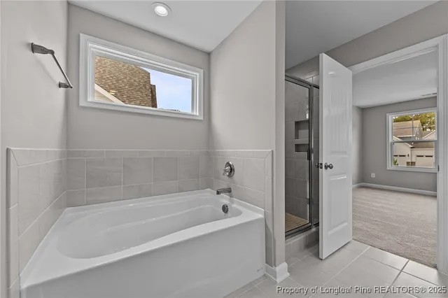a white bath tub sitting next to a window