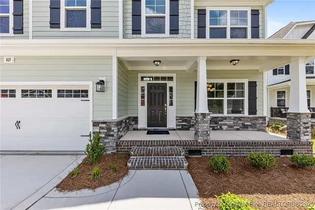 a view of a building with potted plants and a bench