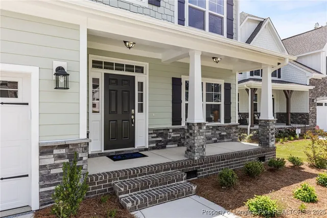 a view of a patio with couches table and chairs and potted plants