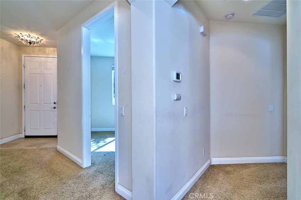 1143 Saguara Road Beaumont, CA 92223 - Photo 43 of 66 a view of a hallway with chandelier