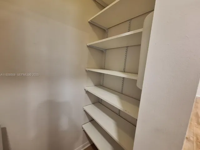 a view of a porch with furniture and a lake view