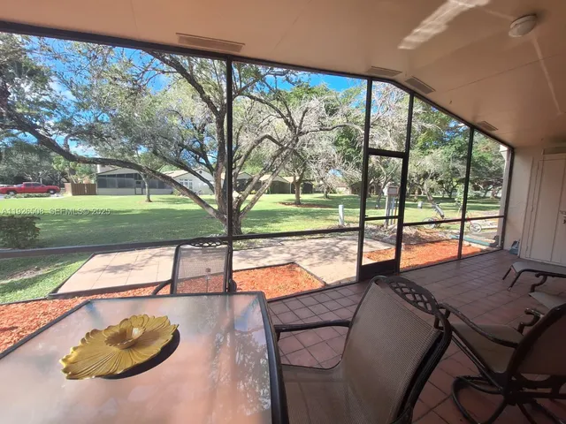 a view of a patio with a table chairs and a table