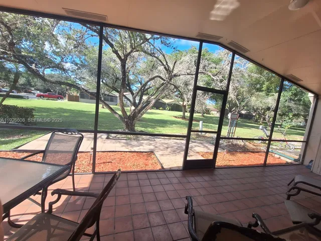 a room with lots of chairs and mirrors