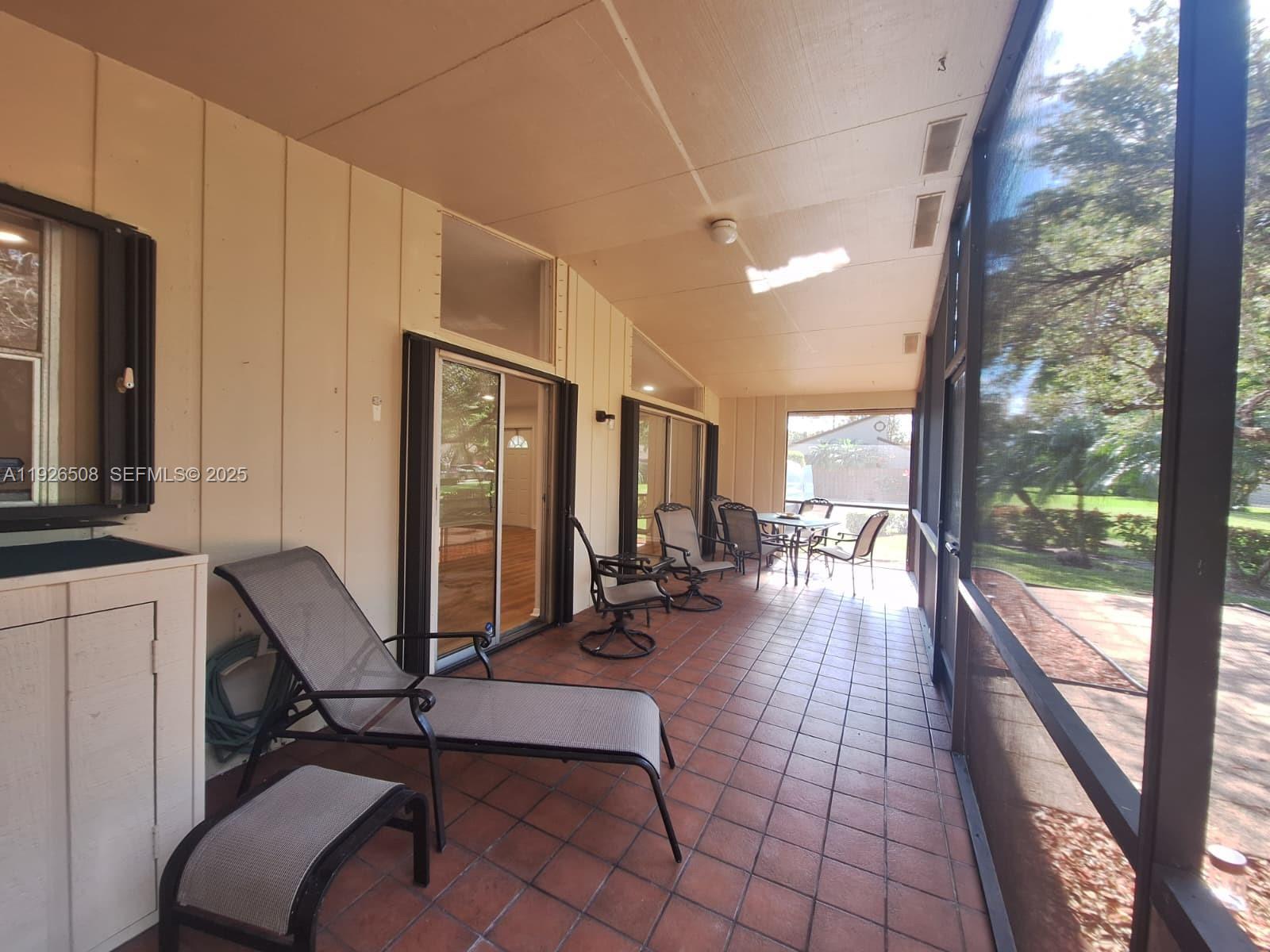 22295 Timberly Drive, Unit 22295 Boca Raton, FL 33428 - Photo 17 of 68 a room with lots of chairs and mirrors