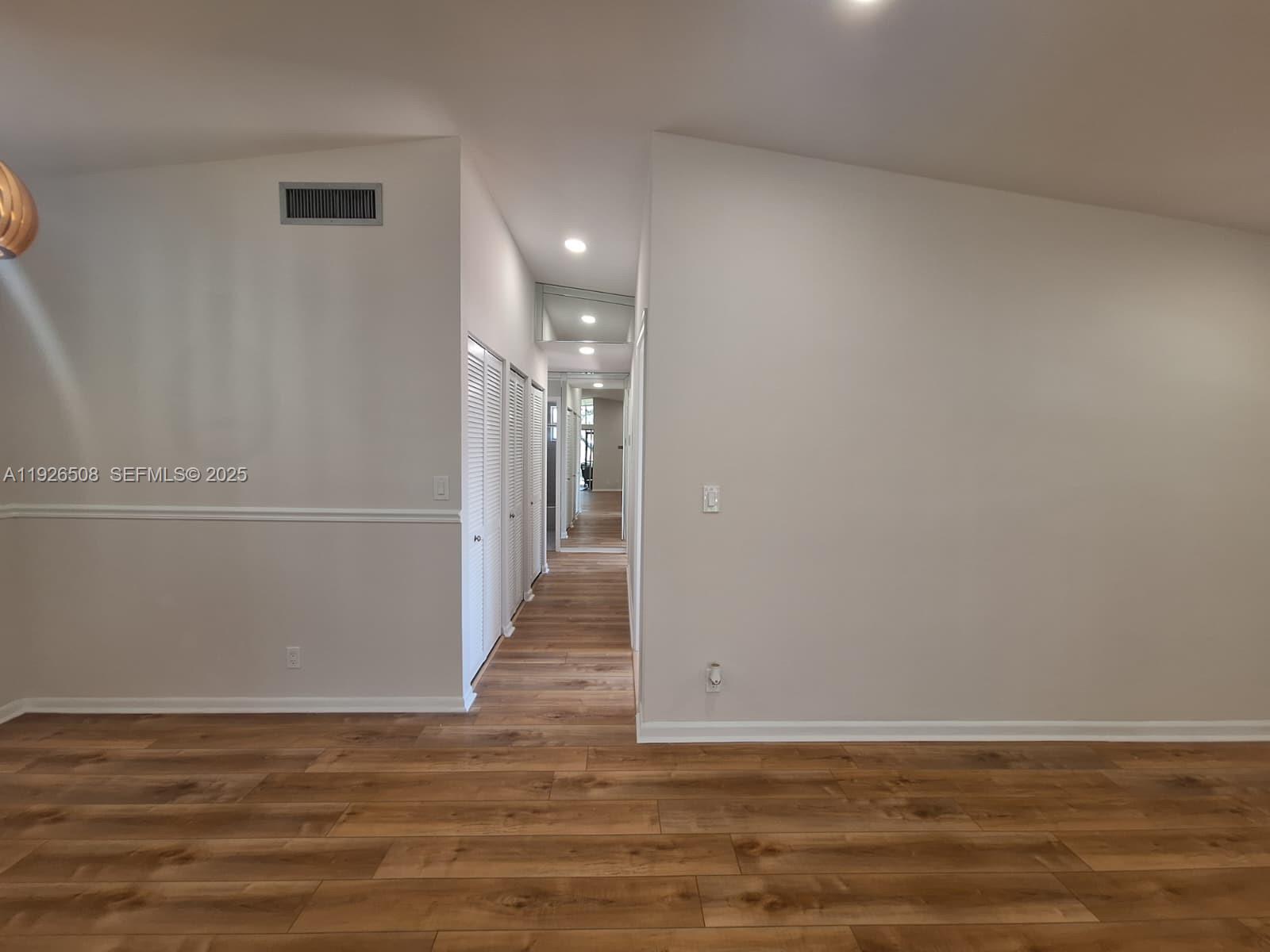 22295 Timberly Drive, Unit 22295 Boca Raton, FL 33428 - Photo 19 of 68 a view of a hallway with wooden floor