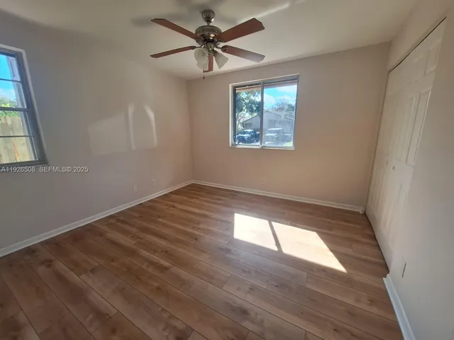 a bathroom with a double vanity sink and mirror with toilet