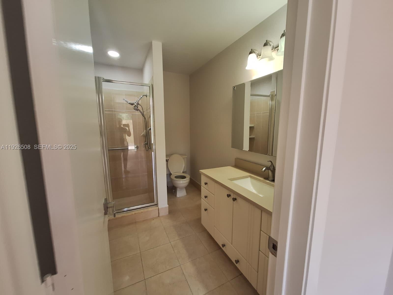 22295 Timberly Drive, Unit 22295 Boca Raton, FL 33428 - Photo 29 of 68 a bathroom with a granite countertop sink mirror and a toilet