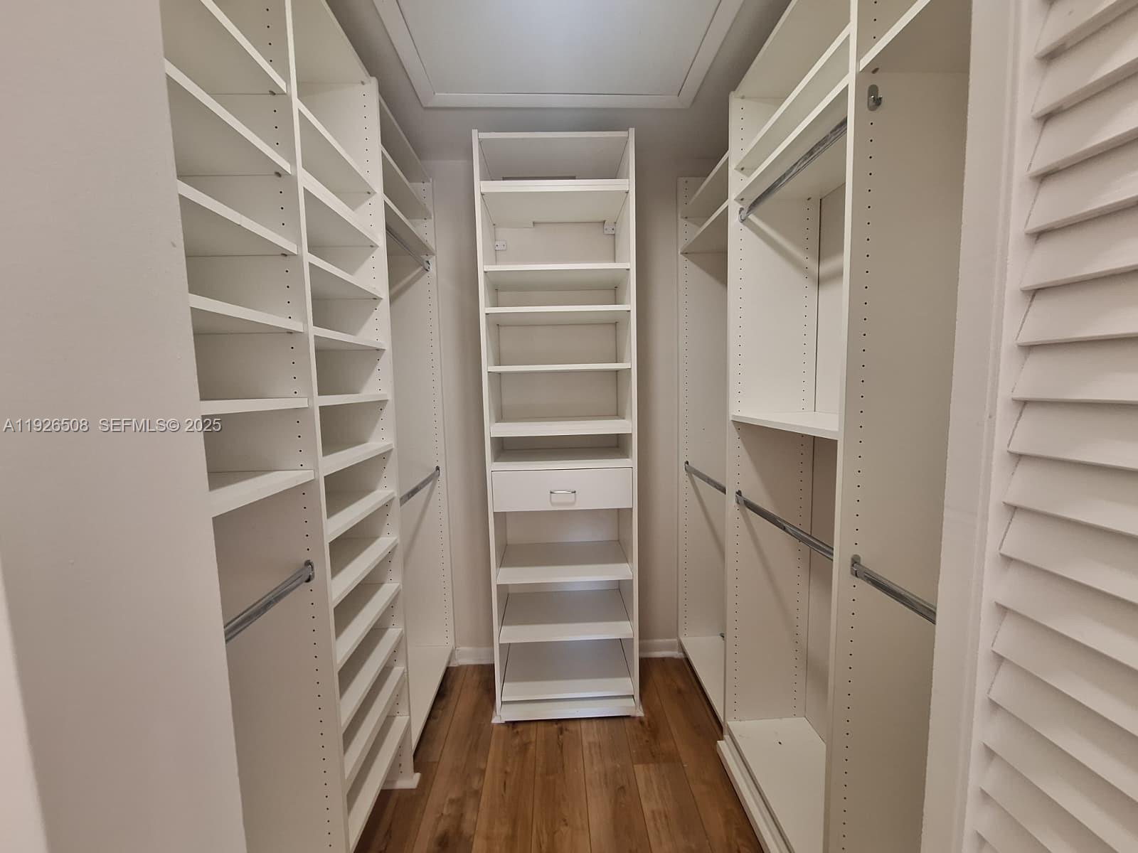 22295 Timberly Drive, Unit 22295 Boca Raton, FL 33428 - Photo 31 of 68 a view of walk in closet with empty racks