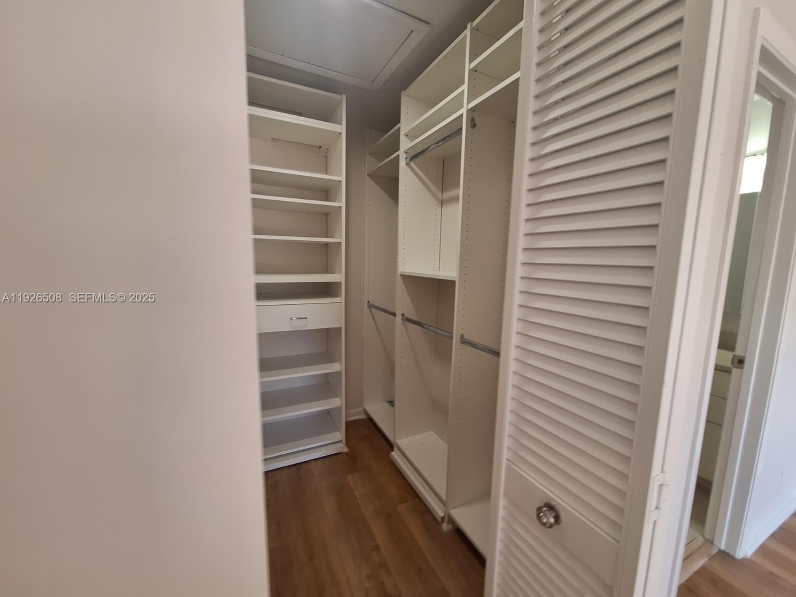 22295 Timberly Drive, Unit 22295 Boca Raton, FL 33428 - Photo 32 of 68 a view of walk in closet with empty racks