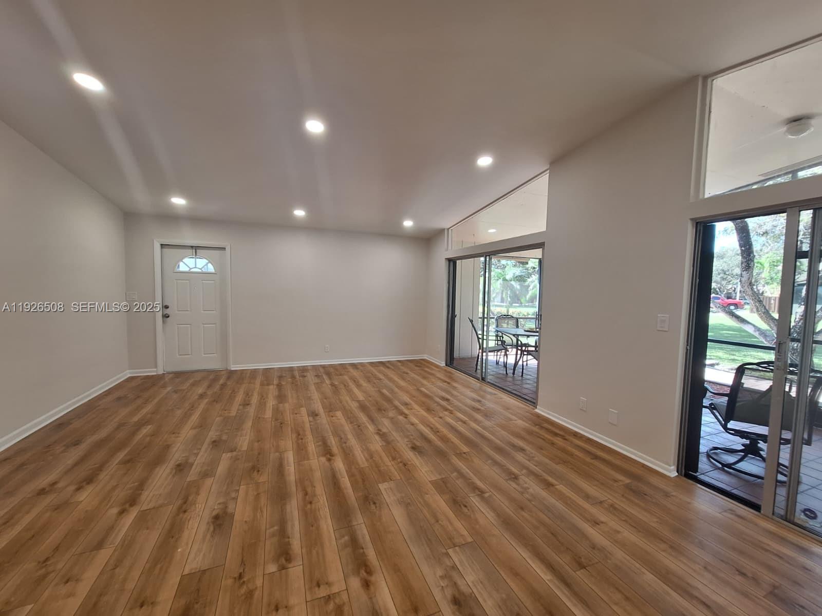 22295 Timberly Drive, Unit 22295 Boca Raton, FL 33428 - Photo 4 of 68 a view of empty room with wooden floor and fan