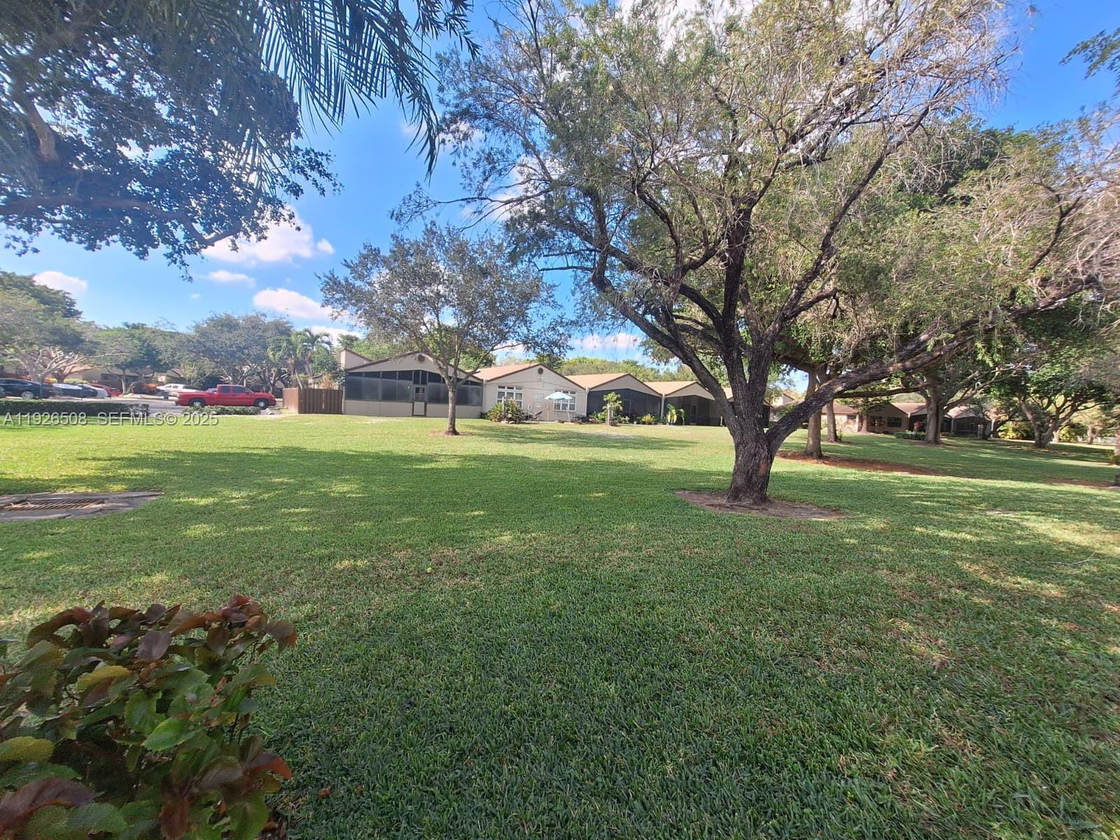 22295 Timberly Drive, Unit 22295 Boca Raton, FL 33428 - Photo 41 of 68 a view of a field with large trees