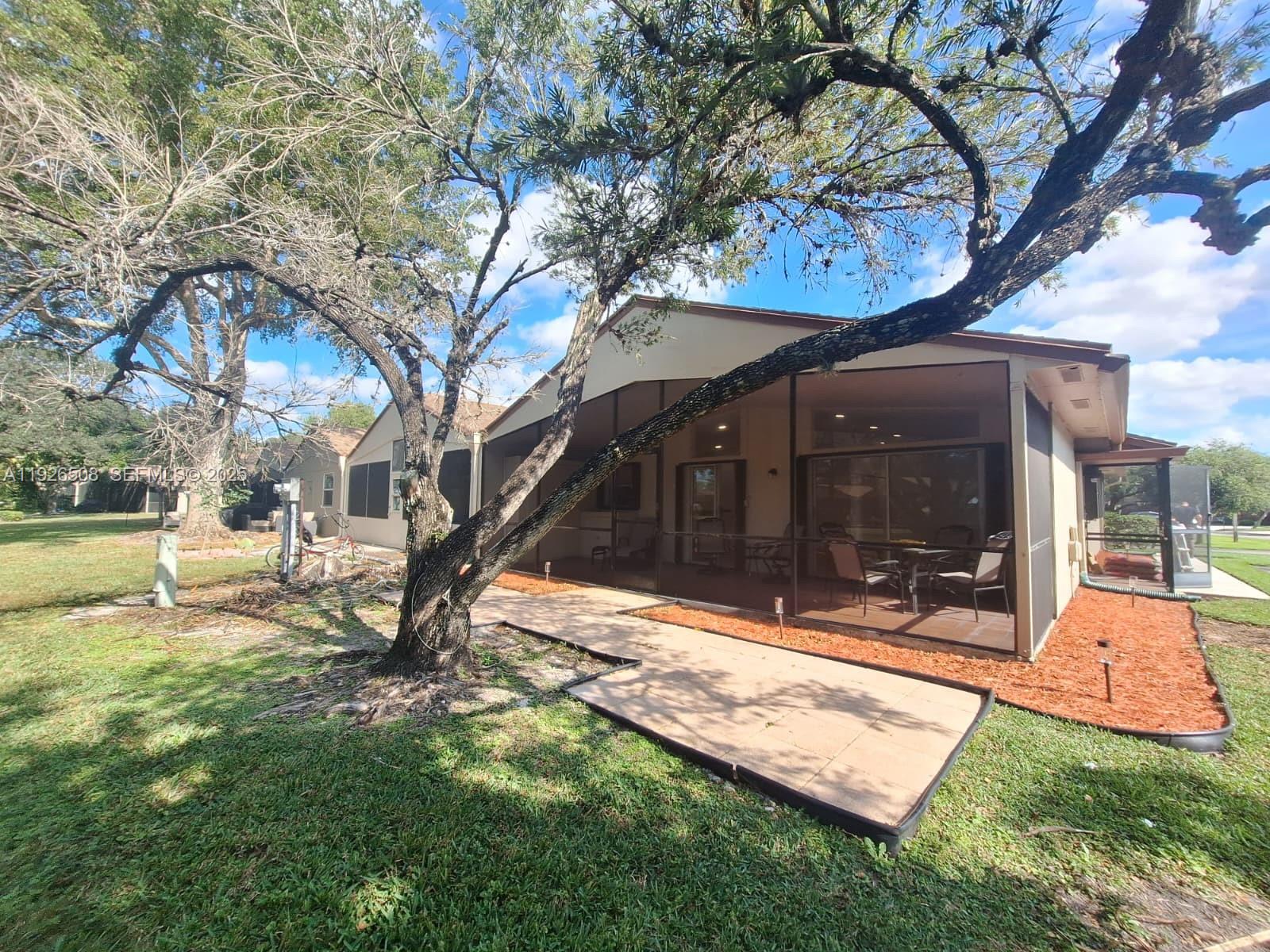 22295 Timberly Drive, Unit 22295 Boca Raton, FL 33428 - Photo 46 of 68 a view of a backyard with a garden